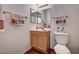 A charming bathroom with a wooden vanity, decorative mirror, and a toilet at 6641 Silverstream Ave # C, Las Vegas, NV 89107