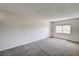 Bright bedroom featuring carpet, textured walls, and a window providing natural light at 6641 Silverstream Ave # C, Las Vegas, NV 89107
