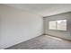 Bright bedroom with carpet, white walls, and a window looking to the exterior at 6641 Silverstream Ave # C, Las Vegas, NV 89107