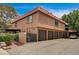 View of the home's exterior features multiple garages with an upper balcony at 6641 Silverstream Ave # C, Las Vegas, NV 89107