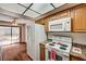 Bright kitchen with a modern refrigerator, electric range, and sliding glass door to the exterior at 6641 Silverstream Ave # C, Las Vegas, NV 89107