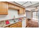 Cozy kitchen featuring stainless steel sink, dishwasher, and natural light from the sliding glass door at 6641 Silverstream Ave # C, Las Vegas, NV 89107