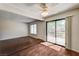 Hardwood flooring in living room that has a door to the backyard, with a ceiling fan at 6641 Silverstream Ave # C, Las Vegas, NV 89107