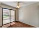 Large living room showcasing a ceiling fan, hardwood floors, and sliding glass doors to the backyard at 6641 Silverstream Ave # C, Las Vegas, NV 89107
