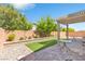 Backyard featuring artificial turf, patio, pergola, privacy walls and landscaping at 7070 Cinder Horse St, Las Vegas, NV 89131