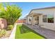 Backyard featuring artificial turf, patio, pergola, privacy walls and landscaping at 7070 Cinder Horse St, Las Vegas, NV 89131