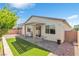 Private backyard with a patio cover, manicured lawn, and mature landscaping for outdoor enjoyment at 7070 Cinder Horse St, Las Vegas, NV 89131