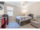 Bedroom featuring plush carpet, ceiling fan, and large window at 7070 Cinder Horse St, Las Vegas, NV 89131