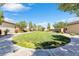 A grassy common area with sidewalks and landscaping is shown at 7070 Cinder Horse St, Las Vegas, NV 89131
