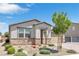 Single story home featuring desert landscaping, decorative rock facade, a brick driveway, and a two-car garage at 7070 Cinder Horse St, Las Vegas, NV 89131