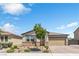 Charming single-story home with desert landscaping, stone accents, and a two-car garage at 7070 Cinder Horse St, Las Vegas, NV 89131
