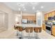 Bright kitchen featuring an island with seating, stainless steel appliances, and a walk-in pantry at 7070 Cinder Horse St, Las Vegas, NV 89131