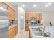 Bright kitchen featuring granite countertops, a stainless steel fridge, maple cabinets, and a pantry at 7070 Cinder Horse St, Las Vegas, NV 89131