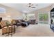 Inviting living room with plush sofas, a ceiling fan, and a sliding glass door leading to the outdoors at 7070 Cinder Horse St, Las Vegas, NV 89131