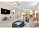 Spacious living room with ample seating, a large TV, and access to other rooms in the house at 7070 Cinder Horse St, Las Vegas, NV 89131