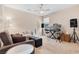 Living room with ceiling fan and multiple seating options with speakers and instruments at 7070 Cinder Horse St, Las Vegas, NV 89131