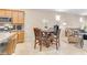 Eat-in kitchen and living room area with tile flooring, a dining table, and a comfortable seating area at 7070 Cinder Horse St, Las Vegas, NV 89131