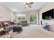 Bright living room with modern furnishings, a TV, and access to the backyard through sliding glass doors at 7070 Cinder Horse St, Las Vegas, NV 89131
