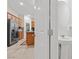 Powder room showing pedestal sink next to kitchen with granite counters and stainless fridge at 7070 Cinder Horse St, Las Vegas, NV 89131