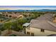 Aerial view of a suburban neighborhood, mountains in the distance, tiled roofs, and mature trees at 724 Step Beach St, Las Vegas, NV 89138