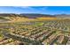 Extensive aerial view showcasing the community's layout with numerous homes against a mountain backdrop at 724 Step Beach St, Las Vegas, NV 89138