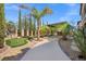 Landscaped backyard with putting green, mature palms and outdoor kitchen at 724 Step Beach St, Las Vegas, NV 89138