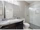 Modern bathroom featuring glass-enclosed shower, large vanity with marble countertop, and toilet at 724 Step Beach St, Las Vegas, NV 89138