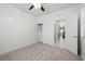 Carpeted bedroom with closet and neutral walls adjacent to open door and staircase at 724 Step Beach St, Las Vegas, NV 89138