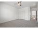 Carpeted bedroom with a ceiling fan, closet, and adjoining bathroom access at 724 Step Beach St, Las Vegas, NV 89138