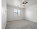 Carpeted bedroom featuring a ceiling fan and bright window at 724 Step Beach St, Las Vegas, NV 89138
