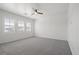 Bright, carpeted bedroom with multiple windows and a ceiling fan at 724 Step Beach St, Las Vegas, NV 89138