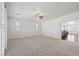 Large, carpeted bedroom with a ceiling fan and plenty of natural light from shuttered windows at 724 Step Beach St, Las Vegas, NV 89138