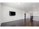 Bright bonus room boasts hardwood floors, a mounted television, and modern finishes at 724 Step Beach St, Las Vegas, NV 89138