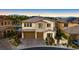 Aerial view of a two-story home featuring stone accents, a two-car garage, and landscaped front yard at 724 Step Beach St, Las Vegas, NV 89138