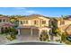 Attractive two-story home with a stone facade, two-car garage, and manicured landscaping at 724 Step Beach St, Las Vegas, NV 89138