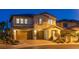 Charming two-story home with a three-car garage, stone accents, and well-manicured landscaping at 724 Step Beach St, Las Vegas, NV 89138