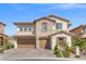Charming two-story home with a stone accent wall and a spacious two-car garage at 724 Step Beach St, Las Vegas, NV 89138