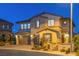 Night view of a two-story home featuring stone accents and well-lit landscaping at 724 Step Beach St, Las Vegas, NV 89138