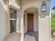 Inviting home entryway features a decorative wood door, charming light fixture, and warm, textured walls at 724 Step Beach St, Las Vegas, NV 89138