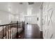 Second-floor hallway with hard wood floors, decorative barn door, and chandelier above staircase at 724 Step Beach St, Las Vegas, NV 89138