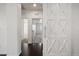 Hallway with dark wood floors and white barn doors leading to other rooms at 724 Step Beach St, Las Vegas, NV 89138