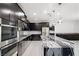 Close-up of a modern kitchen with stainless steel appliances and a marble island at 724 Step Beach St, Las Vegas, NV 89138