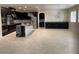 Open concept kitchen with black cabinets, granite counters, stainless appliances and large island at 724 Step Beach St, Las Vegas, NV 89138