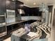Close-up of kitchen featuring stainless steel appliances, granite counters and dark cabinets at 724 Step Beach St, Las Vegas, NV 89138