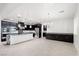 Open kitchen featuring an island with dark cabinets, pendant lighting, and stainless steel appliances at 724 Step Beach St, Las Vegas, NV 89138