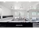 Modern kitchen island featuring a stainless steel sink, stylish pendant lights, and open layout concept at 724 Step Beach St, Las Vegas, NV 89138