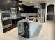 Modern kitchen with dark cabinetry, granite counters, and stainless steel appliances at 724 Step Beach St, Las Vegas, NV 89138
