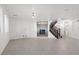 Bright living room with decorative fireplace, tile flooring, staircase, and large windows at 724 Step Beach St, Las Vegas, NV 89138