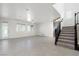 Open floor plan features large-format tile floors, staircase, and glass door to backyard at 724 Step Beach St, Las Vegas, NV 89138