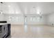 Bright and open living space with a large kitchen island, tile flooring, and plantation shutters at 724 Step Beach St, Las Vegas, NV 89138